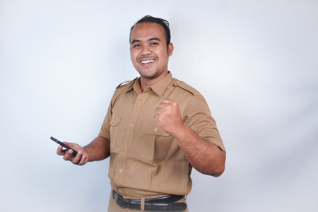 a man Asian civil servants or state civil servants is with brown uniform gesture headband, holding...