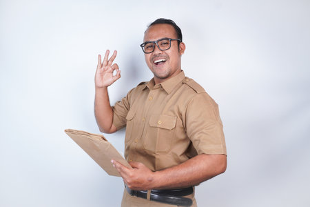a man Asian civil servants or state civil servants is with brown uniform. gesturing carrying...
