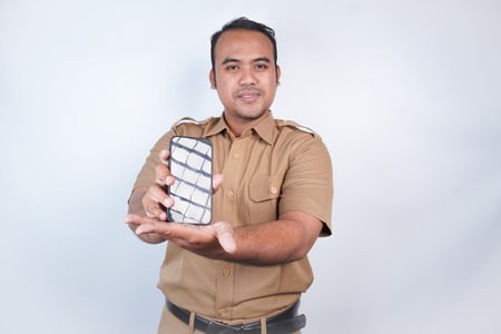 a man smiling Asian civil servants or state civil servants is with brown uniform gesture showing his...