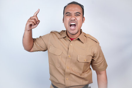 a man Asian civil servants or state civil servants is with brown uniform. gesturing angry will hit,...