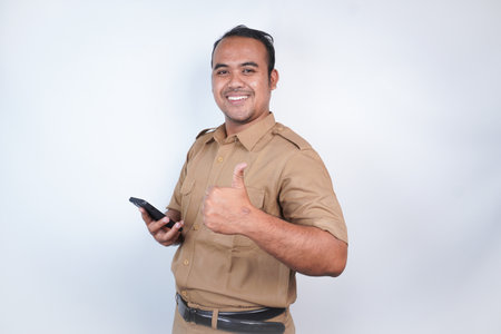 a man smiling Asian civil servants or state civil servants is with brown uniform gesture showing his...