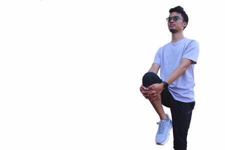 A man is stretching his arm. focus as the man works on his flexibility isolated white backgroundの写真素材