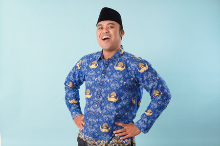 Smiling government worker man wearing kopri blue batik uniform He is posing for a picture PNS, ASN...