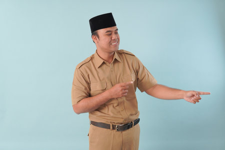 government worker with khaki uniform giving gesturing pointing at the copy space a picture PNS, ASN...