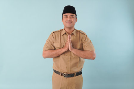 Smiling government worker with khaki uniform He is posing namaste greeting hands picture PNS, ASN...