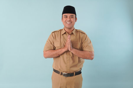 Smiling government worker with khaki uniform He is posing namaste greeting hands picture PNS, ASN civil servant concept.の写真素材