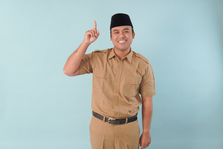 government worker with khaki uniform giving gesturing pointing at the copy space a picture PNS, ASN civil servant concept.の写真素材