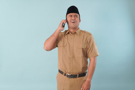 government worker man wearing is talking on his cell phone. He is smiling and he is enjoying PNS,...