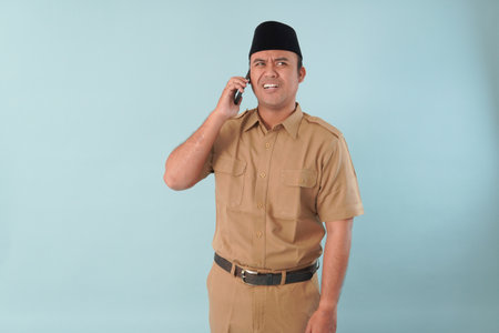 government worker man wearing is talking on his cell phone. He is smiling and he is enjoying PNS,...