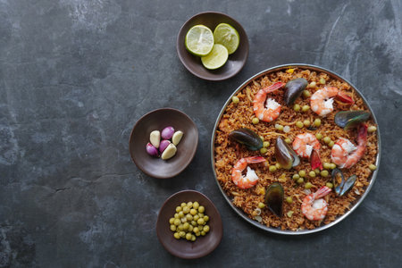 Paella is a Spanish dish made from rice, seafood, shrimp, clams, lemon, peas with saffron seasoning.の写真素材