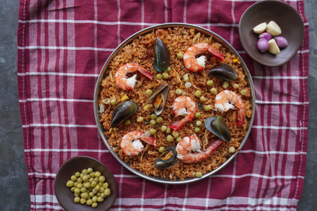 Paella is a Spanish dish made from rice, seafood, shrimp, clams, lemon, peas with saffron seasoning.の写真素材