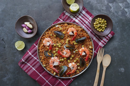 Paella is a Spanish dish made from rice, seafood, shrimp, clams, lemon, peas with saffron seasoning.の写真素材