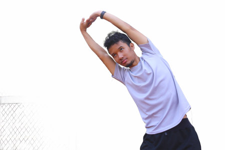 A man is stretching his arm. focus as the man works on his flexibility isolated white background