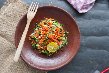 A traditional salad from Java, Indonesia made from fresh vegetables such as cucumber, basil, long...