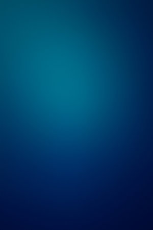 A blue background with no visible objects. The background is very light blue and has a very smooth textureの写真素材