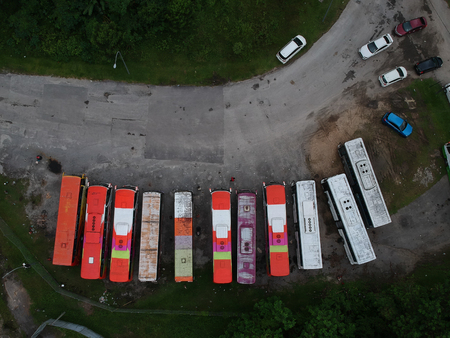 Aerial view colorful old bus park on roadの写真素材