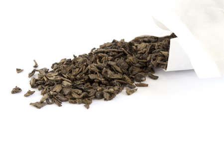 Green tea scattering from a packetの写真素材