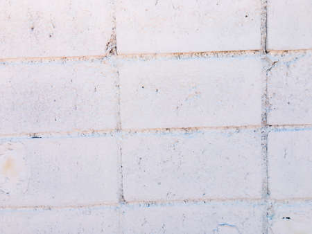 White brick wall texture with crack background for design. の写真素材