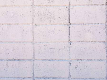 Vintage white brick wall texture with crack background for design. Home and office design backdrop with copy space.の写真素材