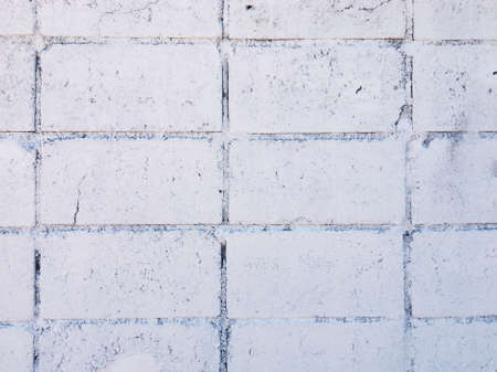 Vintage white brick wall texture with crack background for design. Home and office design backdrop with copy space.の写真素材