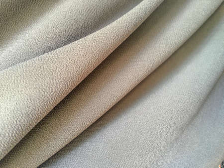 White silk or satin luxury cloth texture background for design. copy space for text, top view.