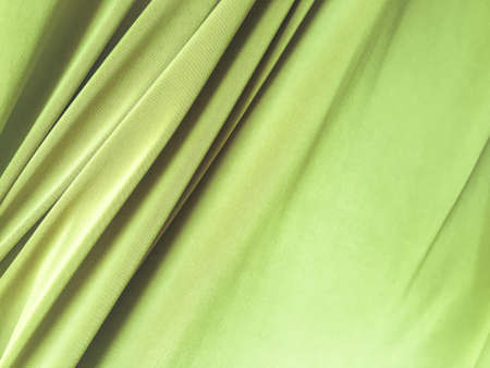 Green fabric texture background with copy space for work and design, top view.