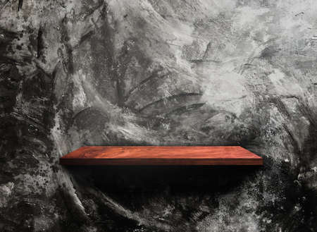 Wooden shelf on concrete wall texture backgroundの写真素材