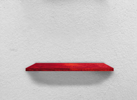 Rustic wooden shelf on grey concrete wall texture backgroundの写真素材