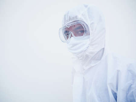 Closeup of asian male doctor or scientist in PPE suite uniform. while looking ahead. coronavirus or COVID-19 concept isolated white backgroundの写真素材
