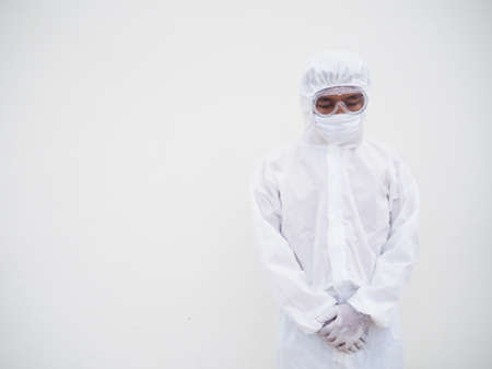 Asian male doctor or scientist in PPE suite uniform with wearing face mask protective. The mood is...