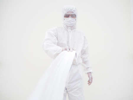 Asian male doctor or scientist in PPE suite uniform holding toilet paper. Lack of toilet paper in...