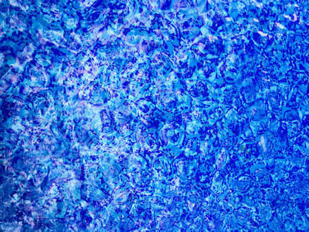 The abstract beauty of clean and clear water in a sparkling pool, creating a mesmerizing ripple pattern.の写真素材