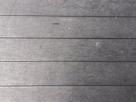 Abstract design with a mix of light and dark wooden planks forming a unique pattern.の写真素材