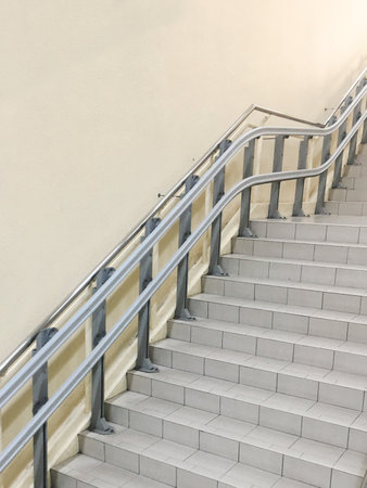 The intricate details of the railing showcase the architectural elegance of the modern stairway.の写真素材