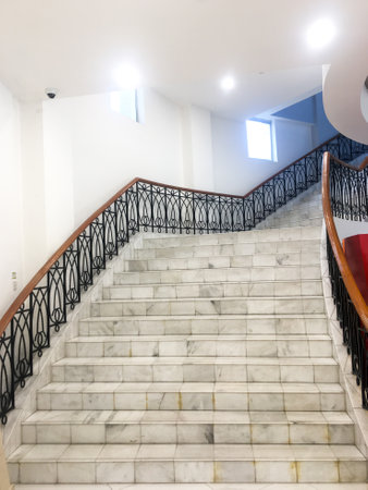 The background of the image features an empty and stylish stairwell, highlighting the minimalistic design.の写真素材
