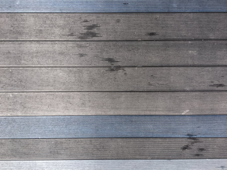 Abstract design with a mix of light and dark wooden planks forming a unique pattern.の写真素材