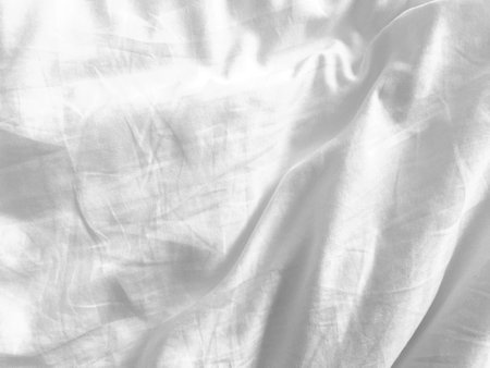 The empty space of this white fabric background offers a clean slate for designers, providing a...