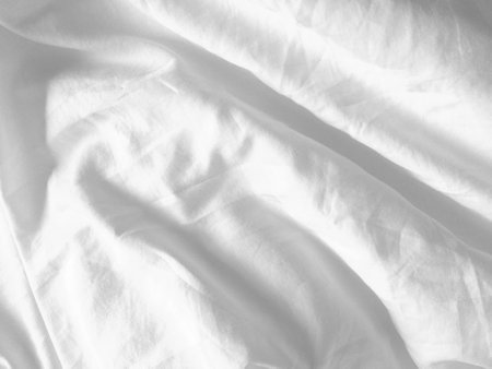 This handmade white fabric, with its subtle wrinkled pattern, adds a touch of uniqueness to any design, providing an empty canvas for creativity.の写真素材