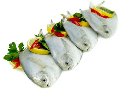 Fresh White Pomfret with Lemon and Chilliesの写真素材