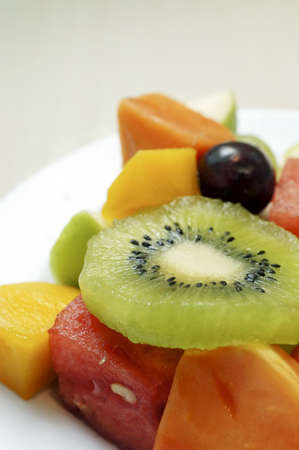 Mixed slices fruits on a plate 