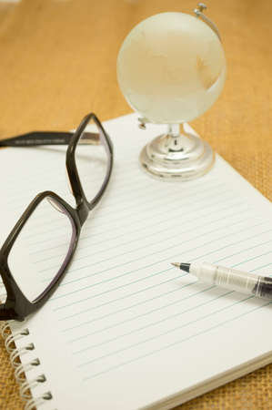 Travel notes concept, blank notes, pen and crystal globeの写真素材