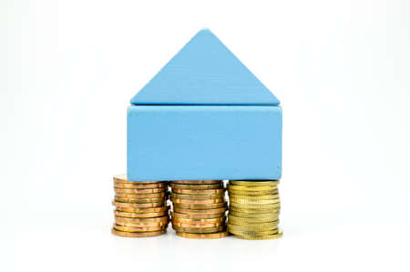 Building blocks house on gold coins, mortgageの写真素材