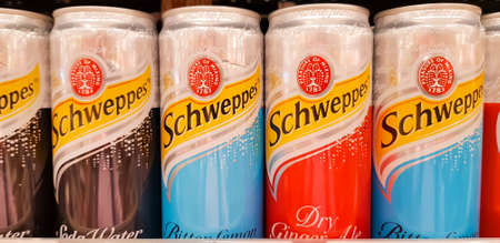 KUALA LUMPUR, MALAYSIA - JANUARY 17, 2018: Cans of soda drinks schweppes. Schweppes Mixers is a range of carbonated drinks manufactured by Coca-Cola in Great Britainのeditorial素材