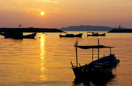 Beautiful Sunset and Silhouette of a Boat at Terengganu, Malaysiaの写真素材