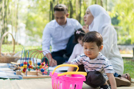 Malay family at recreational park having fun focusing on the little boyの写真素材
