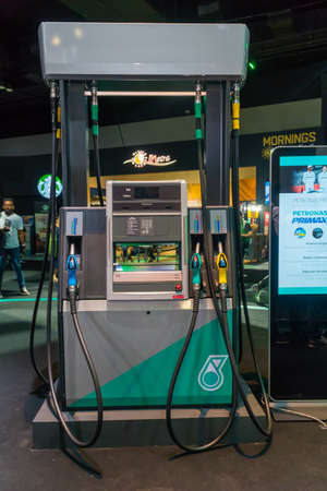 KUALA LUMPUR, MALAYSIA - NOVEMBER 23, 2018: Petronas Gas station pump with fuel nozzleのeditorial素材