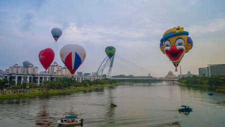 PUTRAJAYA, MALAYSIA - MARCH 29, 2019:The beautiful of multi shaped of hot air balloons floating over sunrise skies at the 10th Putrajaya International Hot Air Balloon Fiesta 2019のeditorial素材