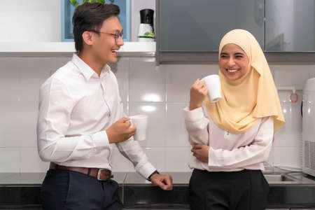 Two young executive malay having a break at pantry