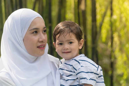 Malay muslim mother and son outdoorの写真素材