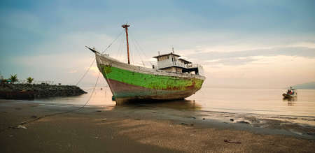 DILI, EAST TIMOR - DECEMBER 6, 2018: Large fisherman ship was anchored on the beach at Dili East Timorのeditorial素材